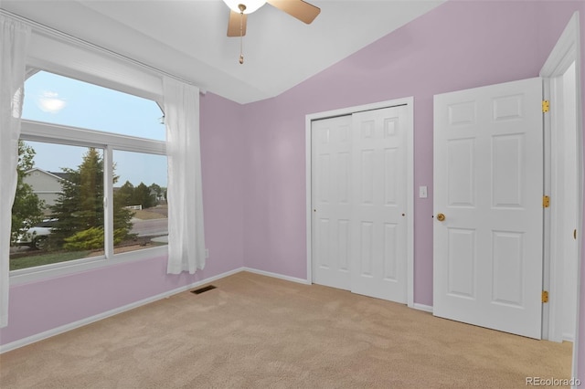 12454 Tex Tan Rd, Peyton, CO 80831 - unfurnished bedroom featuring light colored carpet, vaulted ceiling, baseboards, a closet, and ceiling fan