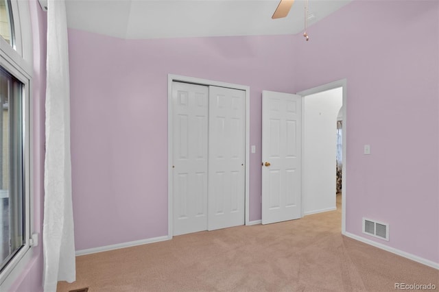 12454 Tex Tan Rd, Peyton, CO 80831 - unfurnished bedroom with light carpet, lofted ceiling, baseboards, a closet, and a ceiling fan