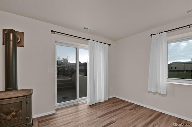 12454 Tex Tan Rd, Peyton, CO 80831 - spare room featuring wood finished floors, baseboards, and a wood stove