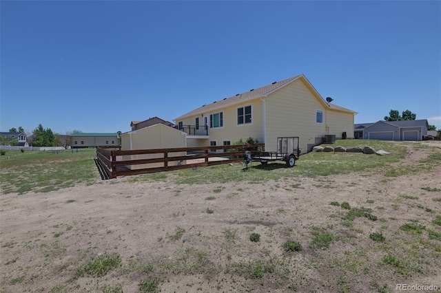 12454 Tex Tan Rd, Peyton, CO 80831 - rear view of property featuring cooling unit and a detached garage