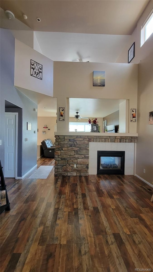 4214 Widener St, Pueblo, CO 81008 - living room featuring high vaulted ceiling, a fireplace, hardwood / wood-style flooring, baseboards, and ceiling fan