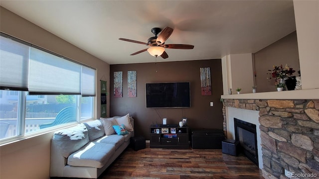 4214 Widener St, Pueblo, CO 81008 - living area featuring dark wood-style flooring, ceiling fan, and a fireplace