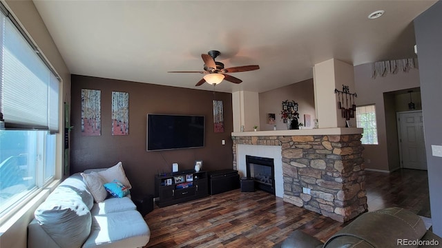 4214 Widener St, Pueblo, CO 81008 - living area with dark wood-style flooring, ceiling fan, and a stone fireplace