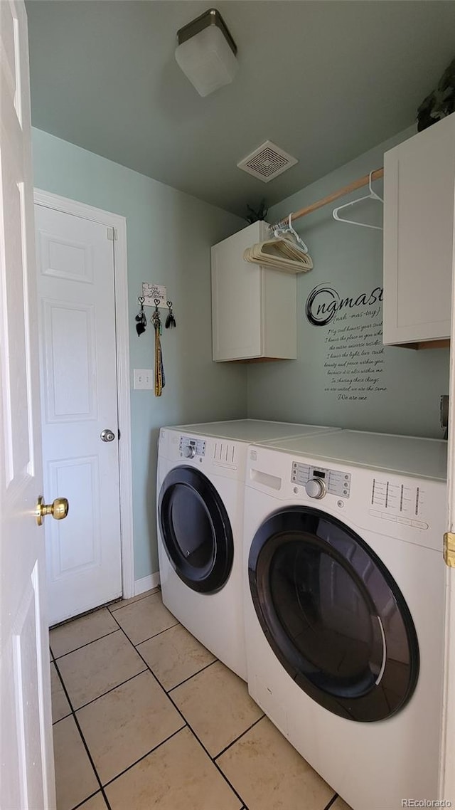 4214 Widener St, Pueblo, CO 81008 - laundry area with cabinet space, independent washer and dryer, light tile patterned floors, and baseboards