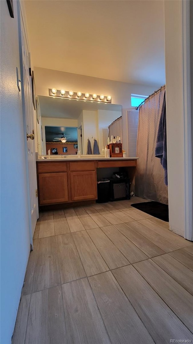 4214 Widener St, Pueblo, CO 81008 - full bathroom featuring double vanity and wood finished floors