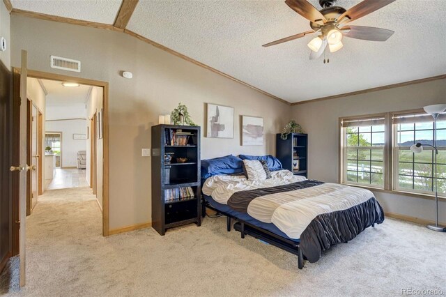 15650 W Valdez Cir, Peyton, CO 80831 - bedroom featuring crown molding, light carpet, vaulted ceiling, a textured ceiling, and baseboards