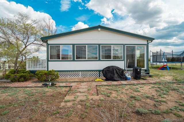 15650 W Valdez Cir, Peyton, CO 80831 - rear view of property featuring a trampoline