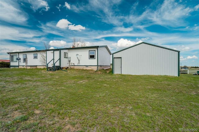 15650 W Valdez Cir, Peyton, CO 80831 - back of property featuring entry steps, a yard, an outdoor structure, and an outbuilding