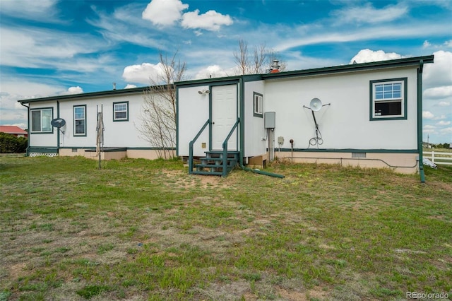 15650 W Valdez Cir, Peyton, CO 80831 - rear view of property featuring entry steps, crawl space, and a lawn