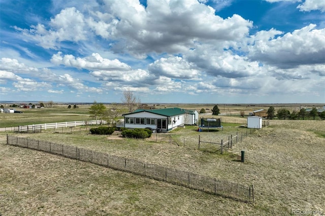 15650 W Valdez Cir, Peyton, CO 80831 - view of front of property featuring a view of rural / pastoral area, an outdoor structure, fence, and a storage unit