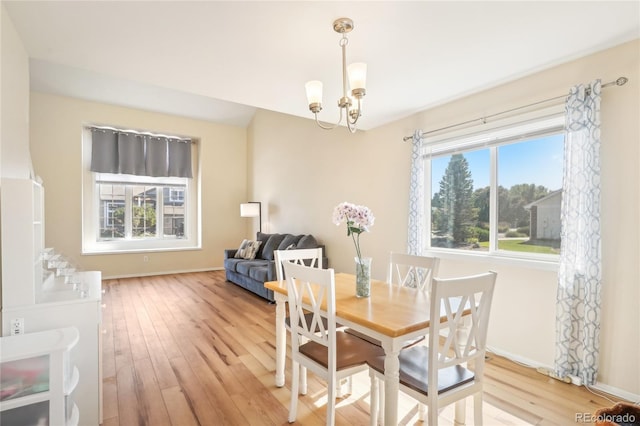 dining room featuring an inviting chandelier and light hardwood / wood-style floors