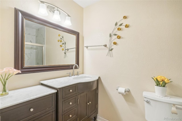 bathroom with vanity, an enclosed shower, and toilet