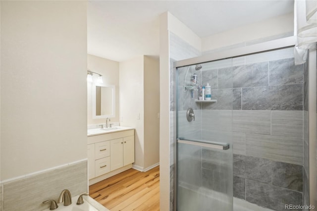 bathroom featuring vanity, hardwood / wood-style flooring, and walk in shower