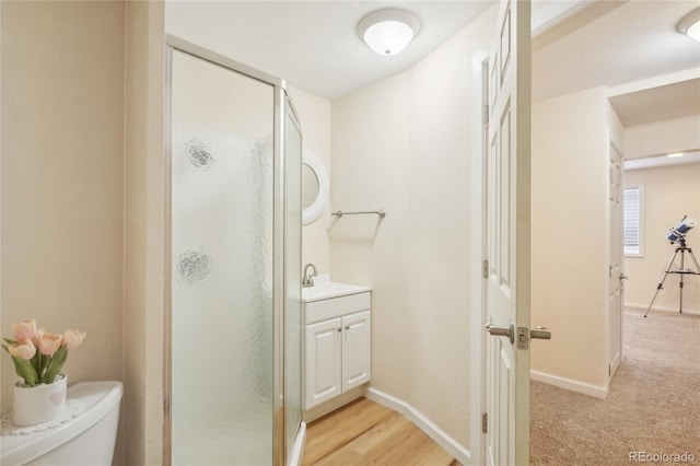 bathroom featuring walk in shower, vanity, and toilet