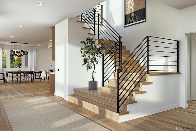 stairs featuring hardwood / wood-style floors