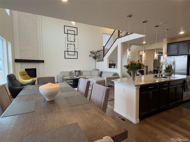 dining area with sink, dark hardwood / wood-style floors, and a fireplace