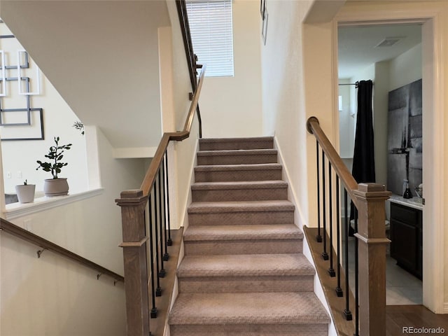 stairs with wood-type flooring