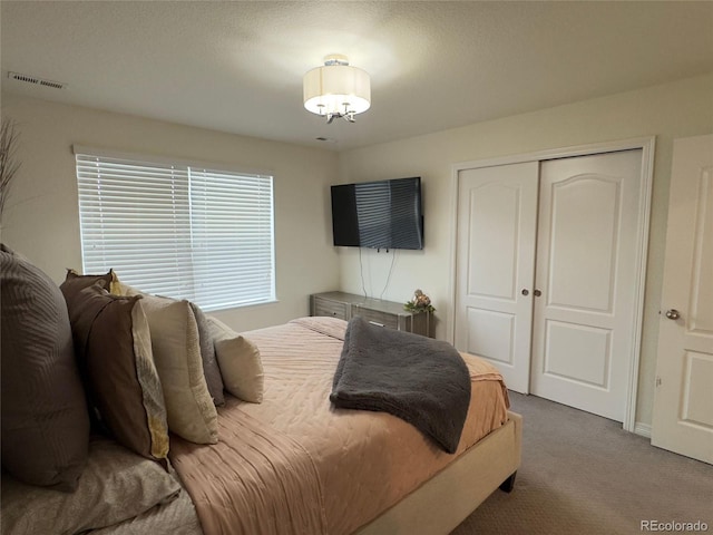 carpeted bedroom featuring a closet