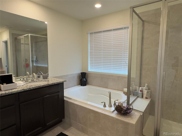 bathroom with vanity, shower with separate bathtub, and tile patterned floors