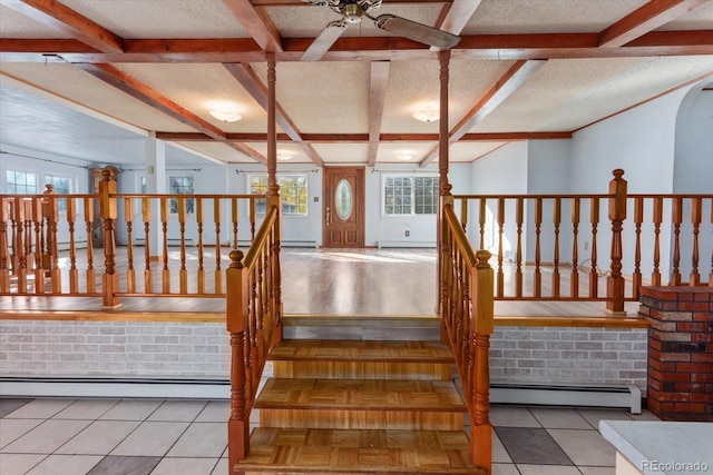 interior space featuring ceiling fan, tile patterned flooring, and a baseboard heating unit