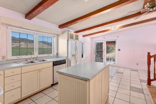 7032 County Road 156c, Salida, CO 81201 - kitchen with white refrigerator with ice dispenser, beam ceiling, stainless steel dishwasher, and cream cabinets