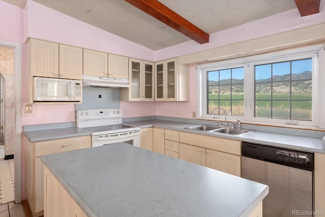 kitchen with white appliances, sink, light tile patterned floors, lofted ceiling with beams, and a mountain view