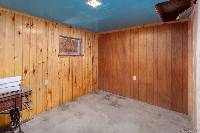 carpeted empty room with wood walls