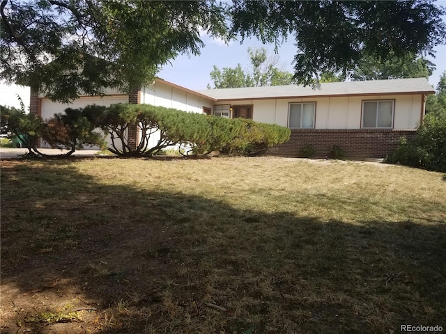 view of side of home with a yard