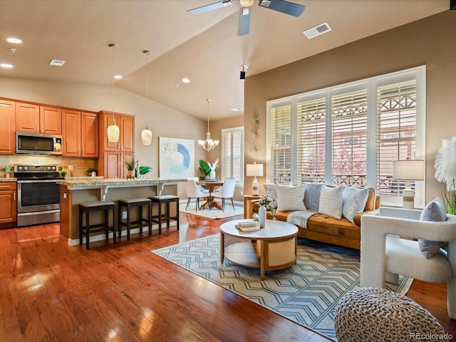11962 W Long Cir Unit 203, Littleton, CO 80127 - living room with dark wood-style floors, lofted ceiling, a chandelier, a ceiling fan, and recessed lighting