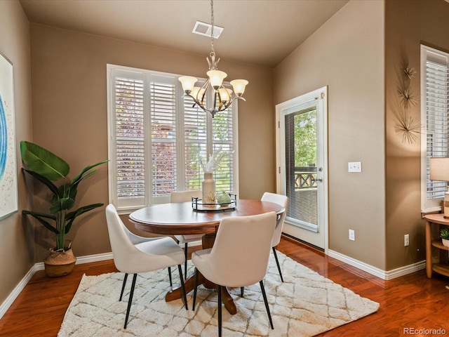 11962 W Long Cir Unit 203, Littleton, CO 80127 - dining room featuring a chandelier and wood finished floors