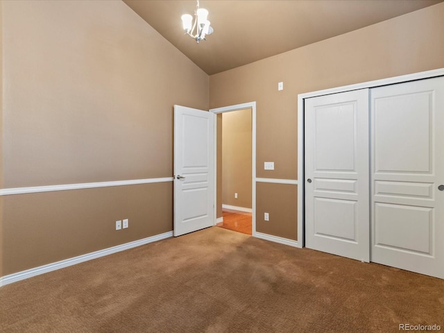 11962 W Long Cir Unit 203, Littleton, CO 80127 - unfurnished bedroom featuring carpet floors, vaulted ceiling, a closet, and a chandelier