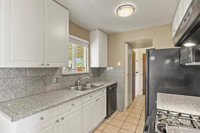 kitchen with a sink, light countertops, white cabinetry, decorative backsplash, and black appliances