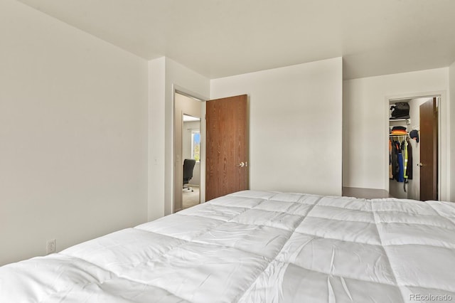 bedroom with a walk in closet and a closet