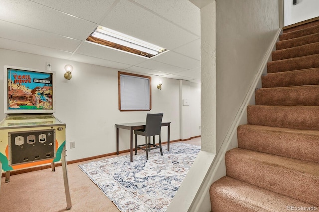 stairway with baseboards, carpet flooring, and a drop ceiling