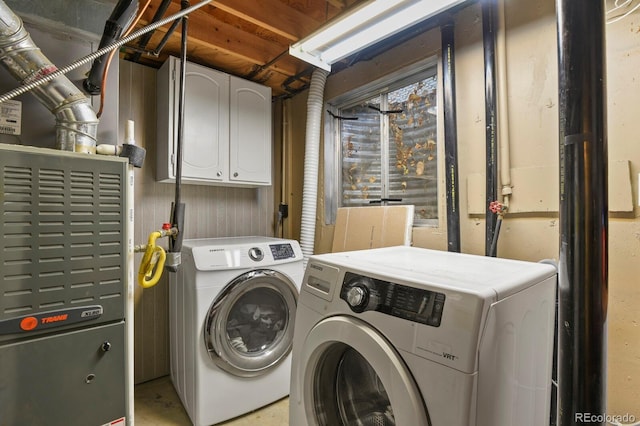 laundry room with separate washer and dryer and cabinet space