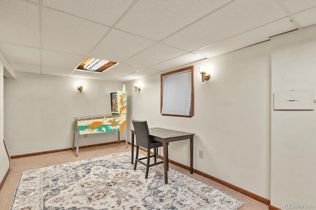 carpeted office with baseboards and a drop ceiling