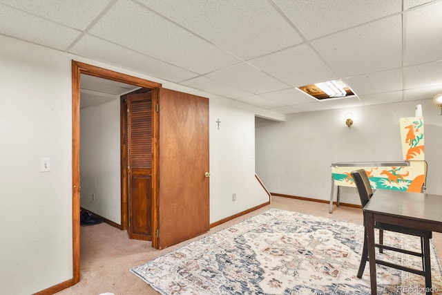 office space with carpet flooring, baseboards, and a paneled ceiling
