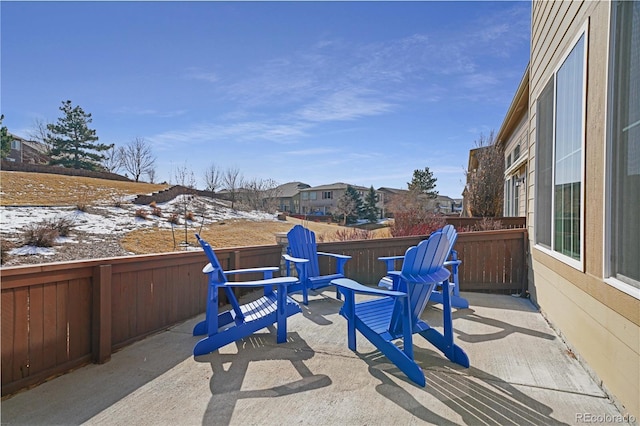 snow covered patio with a residential view