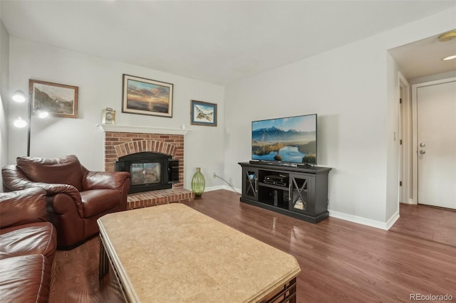 6307 Monterey Pl, Highlands Ranch, CO 80130 - living room with dark wood-style flooring, baseboards, and a brick fireplace