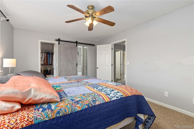 6307 Monterey Pl, Highlands Ranch, CO 80130 - carpeted bedroom featuring baseboards, a ceiling fan, a closet, and a barn door