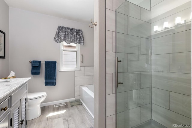 6307 Monterey Pl, Highlands Ranch, CO 80130 - full bath featuring wood finished floors, vanity, a tile shower, toilet, and a bath