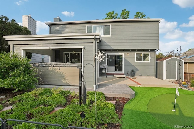 6307 Monterey Pl, Highlands Ranch, CO 80130 - rear view of house with an area to practice putting, a patio area, and a chimney