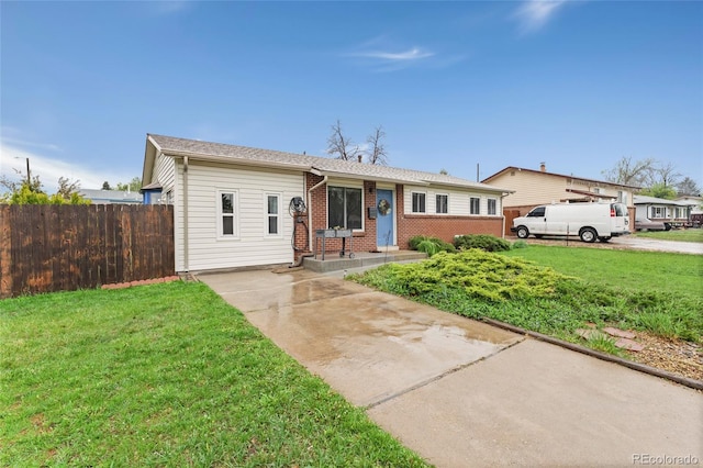 single story home featuring brick siding and concrete driveway