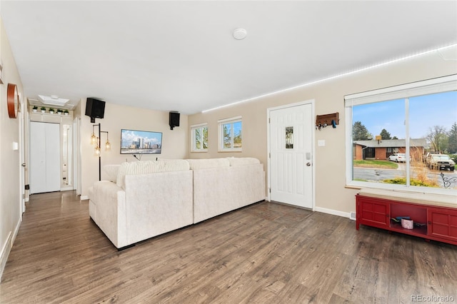 living area with wood finished floors and baseboards