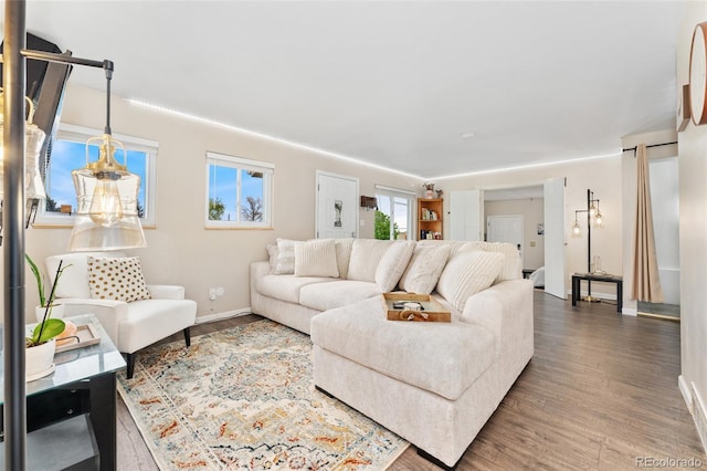 living room featuring wood finished floors and baseboards