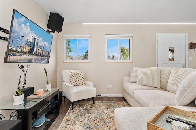 living area with wood finished floors and baseboards