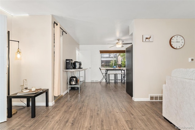 hallway with wood finished floors and baseboards