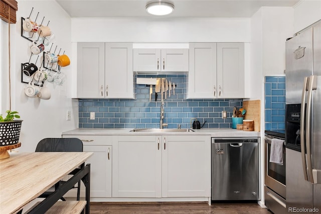 kitchen with stainless steel appliances, light countertops, decorative backsplash, and dark wood-type flooring