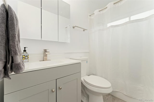 full bath featuring toilet, vanity, and curtained shower