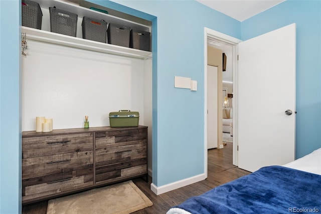bedroom featuring wood finished floors and baseboards